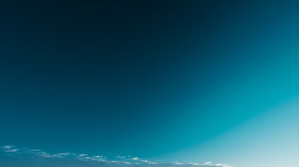 serene sky transitions from deep blue to teal, creating calming ombre effect. Soft clouds drift across horizon, enhancing tranquil atmosphere of this beautiful landscape