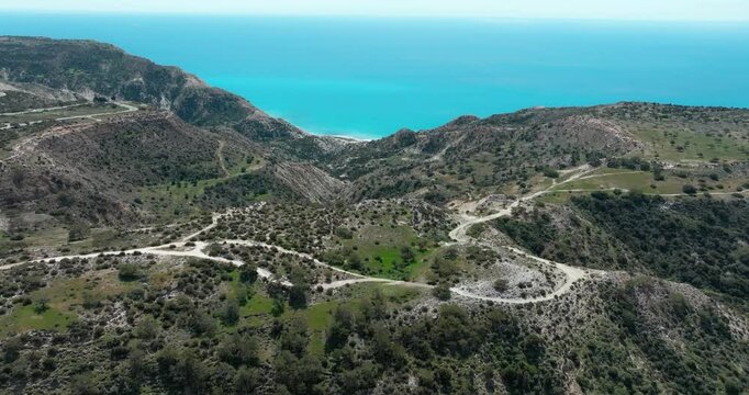 Aerial of Aphrodite's Trail in Cyprus. Wavy coast of the Mountain Sea, sandy sea on the island, beautiful nature, tourism and roads.