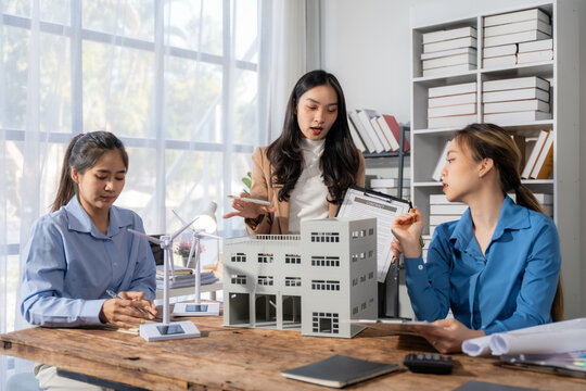 Female Architects Discussing Building Model