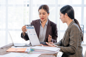 Businesswomen Discussing Financial Report in Office