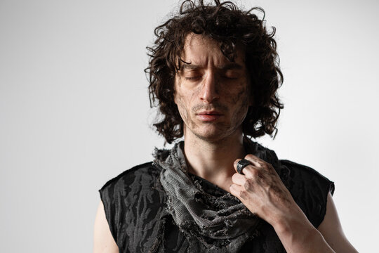 A curly-haired guy in a grunge outfit, a dramatic portrait of a Shakespearean character in a modern way