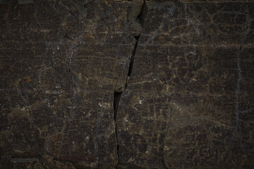 A natural stone texture background with a monolithic rock formation, cracks, and fragments. Ideal...