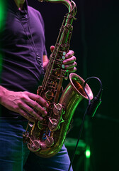 Fototapeta premium Artist musician plays the saxophone illuminated by green light