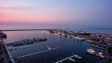 Panoramic marina view at twilight with yachts and pastel evening sky