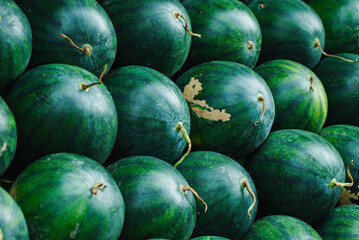 Close up, patterned green watermelons, stacked in front of the shop area, Green and fresh ripe, watermelons from organic fruit farmers