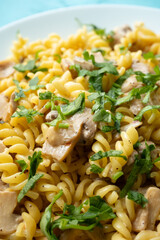 Italian pasta with creamy mushrooms and parsley on white plate in close-up