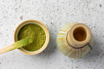 Preparing a matcha tea with powder and bamboo whisk
