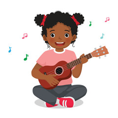 Little African girl playing guitar sitting on floor 
