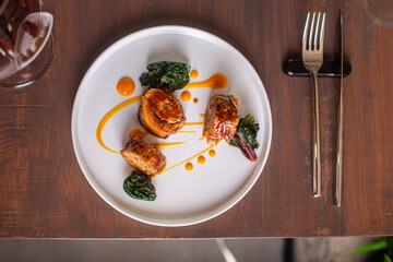 Gourmet dish presentation with succulent meat, vibrant greens, and artistic sauce drizzle culinary art concept