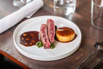Culinary artistry showcasing gourmet beef dish with sauce and dessert on elegant plate dining experience concept