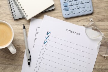 Checklist with marked checkboxes, stationery, coffee and glasses on wooden table, flat lay
