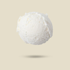 Ice cream scoop in air on beige background. Yummy dessert