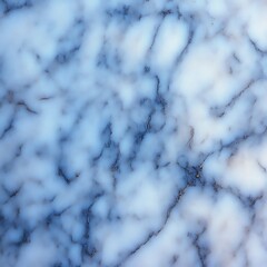 Obraz premium A close-up view of a marble surface with light blue and white tones and dark veins