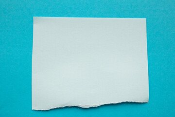 piece of blue paper tear isolated on blue background