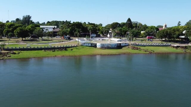 Aerial panorama of Anfiteatro Pinin Palma in Paso de la Patria. Beaches, pier, streets, Isla de los Enamorados, and dorado fishing. Sunny day in a border town with lodgings and camping.