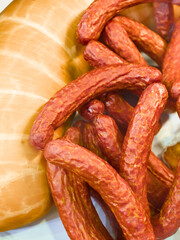 Delicious assortment of smoked sausages and cured meats displayed invitingly on a wooden platter