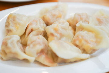 Close-up of a plate of dumplings on white plate, traditional Chinese snack