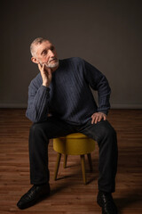 Authentic studio portrait of a handsome older man, selective focus.