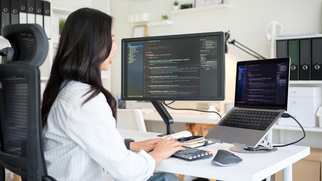 Programmer working on software development in a modern workspace.