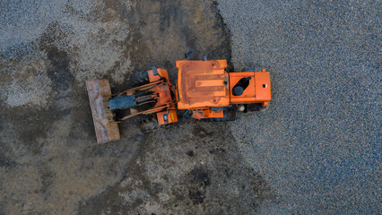Aerial scene of bulldozer in rock sand mine. Construction machinery