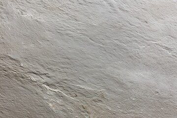 Fototapeta premium A grey stone wall with a rough texture
