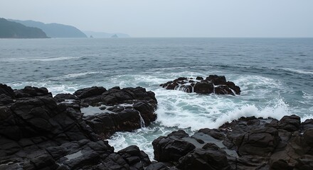 Ocean waves crashing against rocky shore on a cloudy day with distant mountains view landscape 100