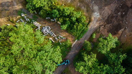 Aerial scenery of lone excavator at abandoned rock and sand mine in the morning