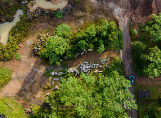 Aerial scenery of lone excavator at abandoned rock and sand mine in the morning