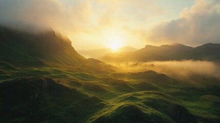 Obraz premium Rolling Green Hills Landscape at Sunrise with Fog and Soft Golden Light