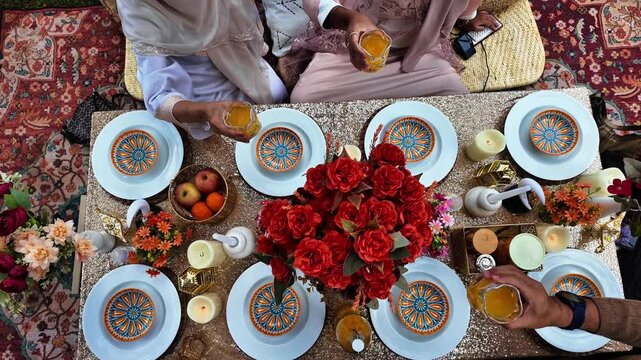 Ramadan iftar Eid. Muslim family has dinner at home. Table with traditional food. Eid al-Fitr celebrations