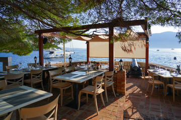 Seaside restaurant in the village of Rose at the tip of the Luštica Peninsula on the eastern shore of the mouth of the bay of Kotor along the coast of the Adriatic Sea in Montenegro