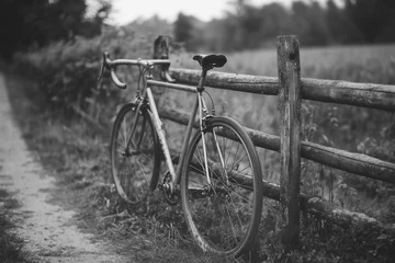 Fotobehang old bicycle on a wooden fence © Ayasha