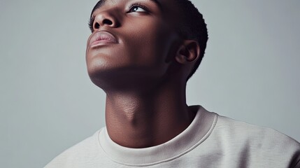 Obraz premium Black male model in stylish sweatshirt, neutral expression - modern minimalism and effortless style