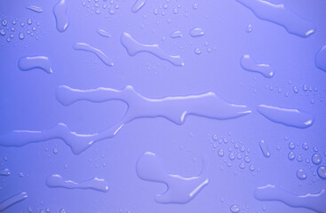 Drops of water on purple background.