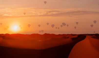 Hot air balloon flying over beautiful sand dunes in the Sahara desert - Sahara, Morocco