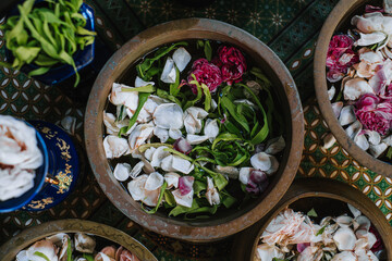 Flower petals with water or Kembang Tujuh Rupa in a traditional clay bowl that used for Javanese wedding ceremony called Siraman