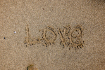 Love written on the beach sand