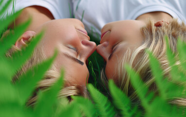 Lying on grass, couple shares intimate moment, surrounded by lush greenery, evoking feelings of love and connection