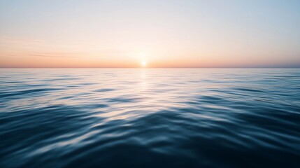 Obraz premium Serene seascape displaying the sun rising or setting over calm, tranquil water