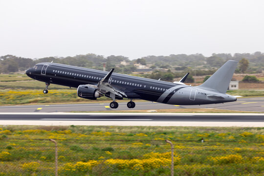 Luqa, Malta - April 16, 2025: Titan Airways Airbus A321-253NX (REG: G-OATW) departing back to the UK as a British Airways flight. 
