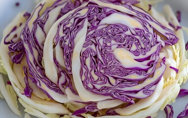 Obraz premium Closeup of Sliced Red Cabbage, Vibrant Purple and White Layers, Fresh Vegetable Texture