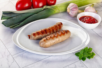 Grilled pork sausages served tomato sauce