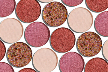 Swatches eyeshadow refills as minimal geometric pattern on white. Glitter pans red, brown, purple, pink shades with sun shadows, detailed texture, cosmetic, beauty concept makeup, top view layout
