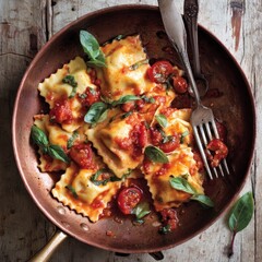 Delicious ravioli in a tomato sauce with fresh basil and cutlery