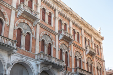 Obraz premium Facade of beautiful building Palazzo delle Debite in central Padova built in neo-romanesque style with vaulted bifora windows and decorative cornices