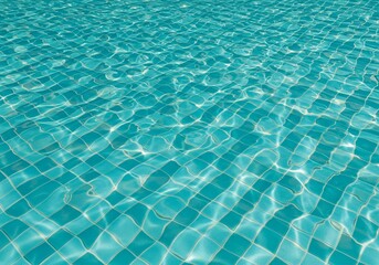 Obraz premium Sunlight dances on the rippling turquoise surface of a swimming pool, creating captivating patterns and subtly showing the underlying pool tile grid.
