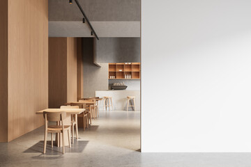 Modern cafe interior with wooden furniture and large blank white wall for poster display or design mockup template in clean minimalist layout concept. 3D Rendering