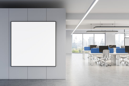 Blank poster mockup on wall in modern office interior with city view and open workspace environment featuring minimalist design elements. 3D Rendering
