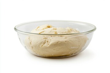 Glass bowl with dough placed on clean white background