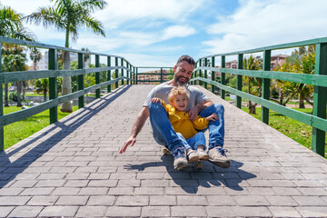 Father embracing son while skateboarding, sharing joyful moment during outdoor recreation